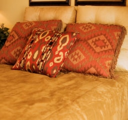 Southwestern style pillows on a bed